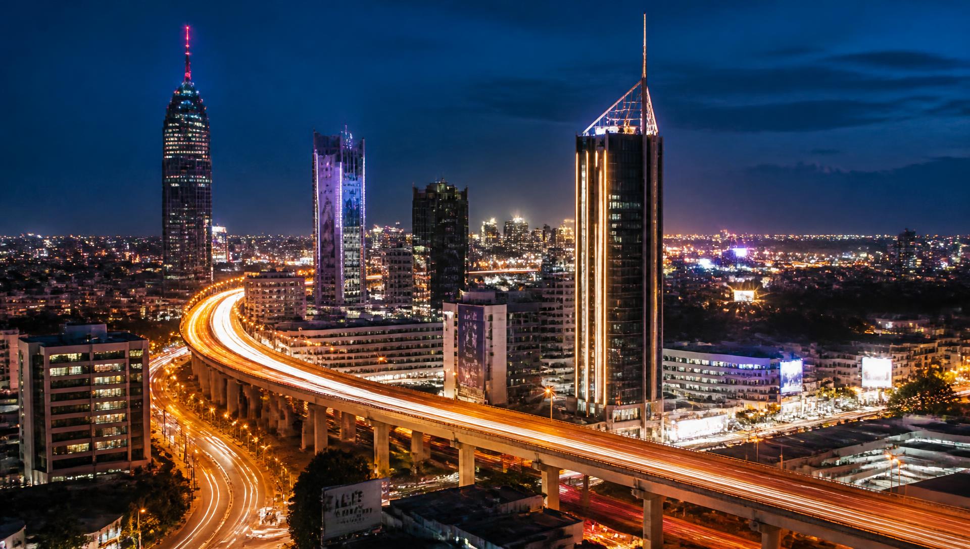 Nairobi skyline at night with the illuminated expressway curving through the city